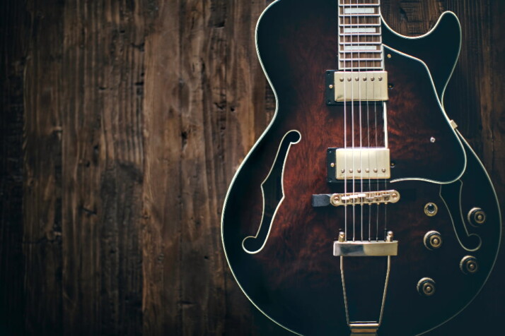 Image of a guitar on a brown surface