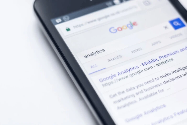 Android smartphone showing a Google search that reads analytics