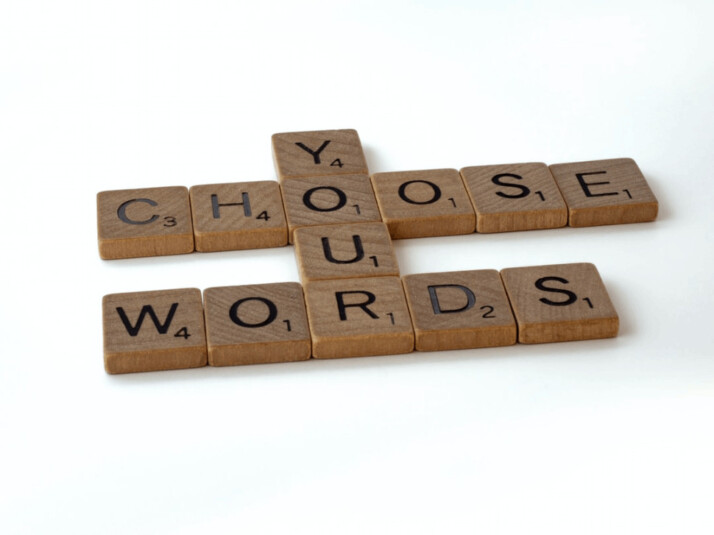 Choose your words brown wooden scrabble blocks on a white background