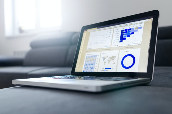 A laptop displaying data made up of charts and graphs.