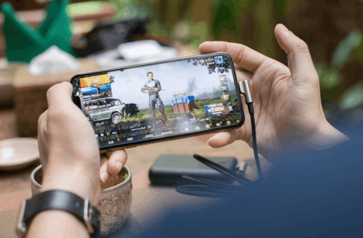 A person playing PUBG game on his mobile device