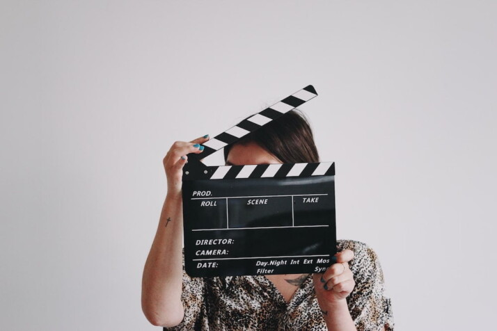 A person holding a clapperboard.