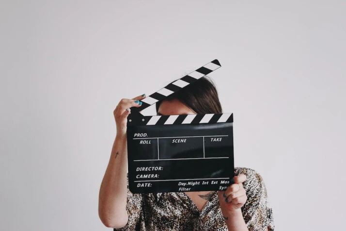 A person holding a clapperboard.