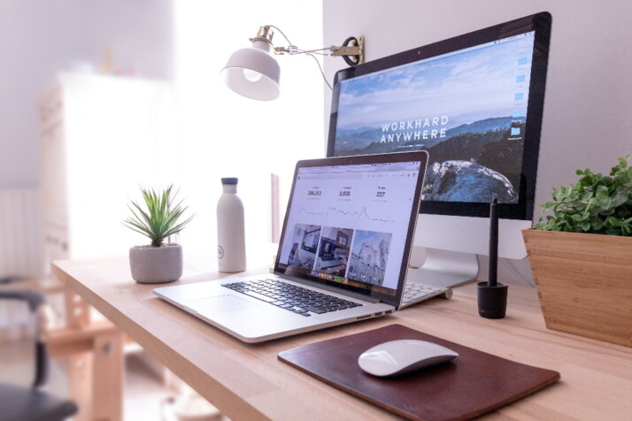 A laptop placed right in front of a computer monitor.