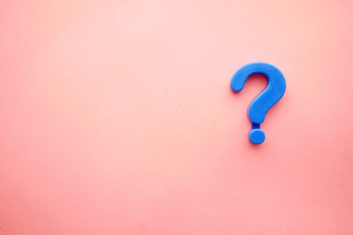 Blue question mark on a pink background