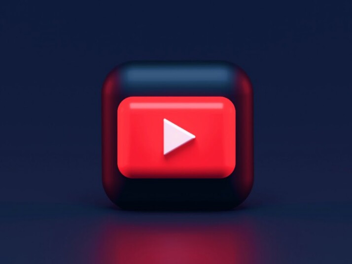 A 3D rendered red play button, the official YouTube logo.