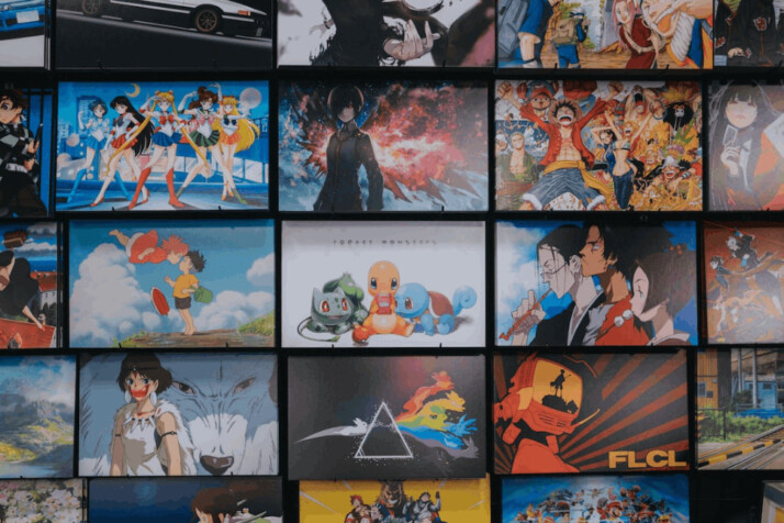 An anime character collage photo on black wooden shelf