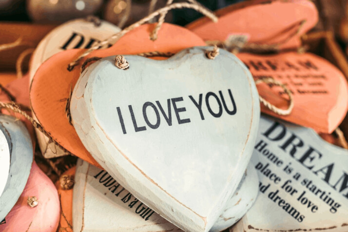 beige and white heart hanging decors displaying I love you words