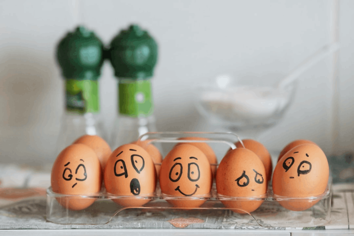 brown eggs with different faces drawn on it to show emotions