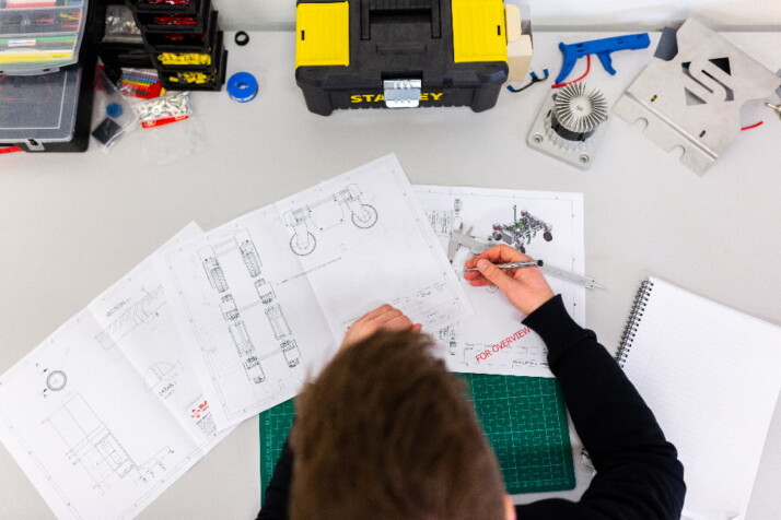 An engineer working drawing a prototype design for something.