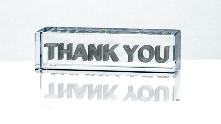 A 3D Thank You signage that is made of glass.