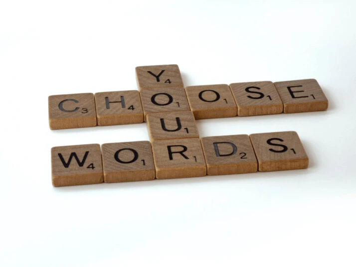 Choose your words brown scrabble blocks on a white surface