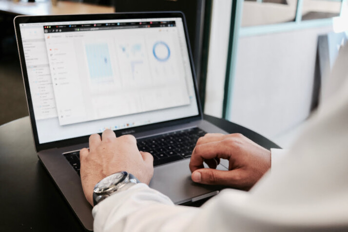 An image of a person working on their laptop, with the screen blurred.