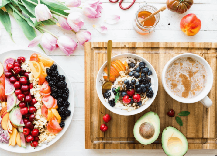 Healthy breakfast showing black and red cherries on white bowl