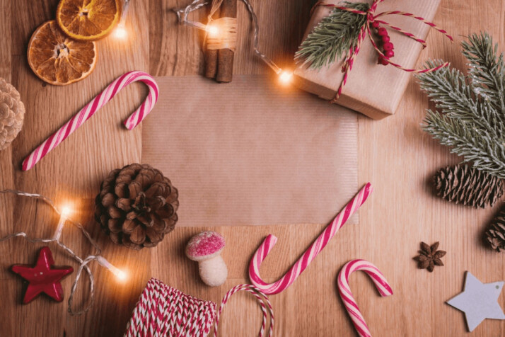 assorted Christmas ornaments and lights on a wooden table