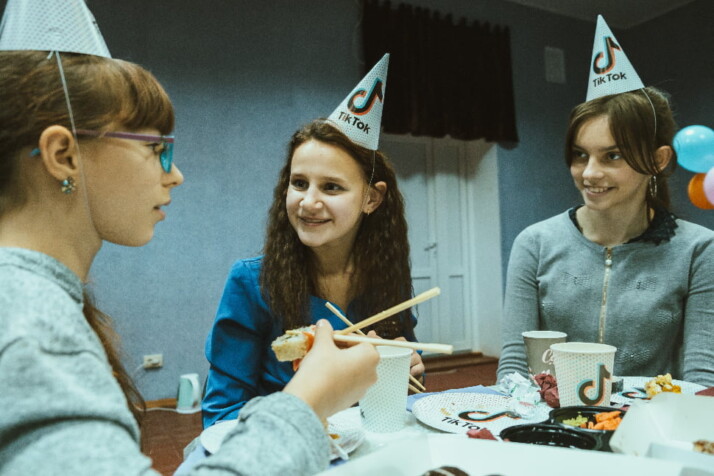 A TikTok themed birthday with hats and cups with the TikTok logo.