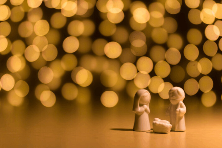 shallow focus photo of the Nativity figurine with star-looking lights behind