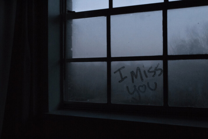 photo of a foggy window that reads I miss you