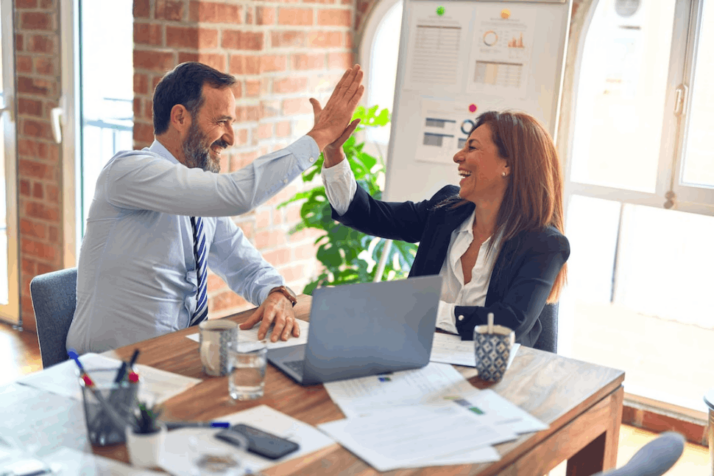 An Image of co-workers high fiving.