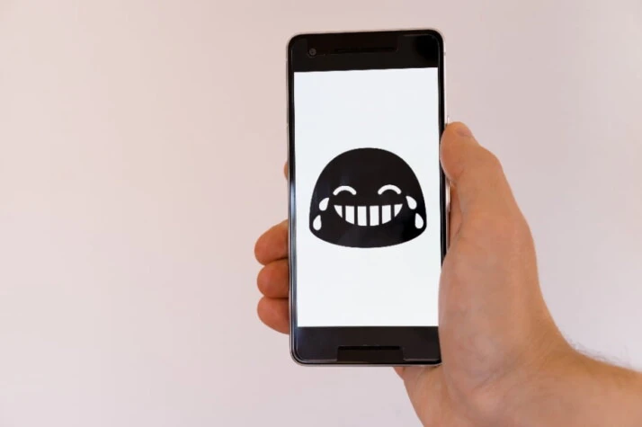 An emoji that's laughing with tears streaming from its eyes.