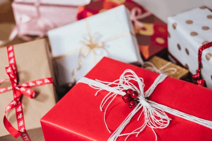 Red, white, and beige gift boxes placed on the ground