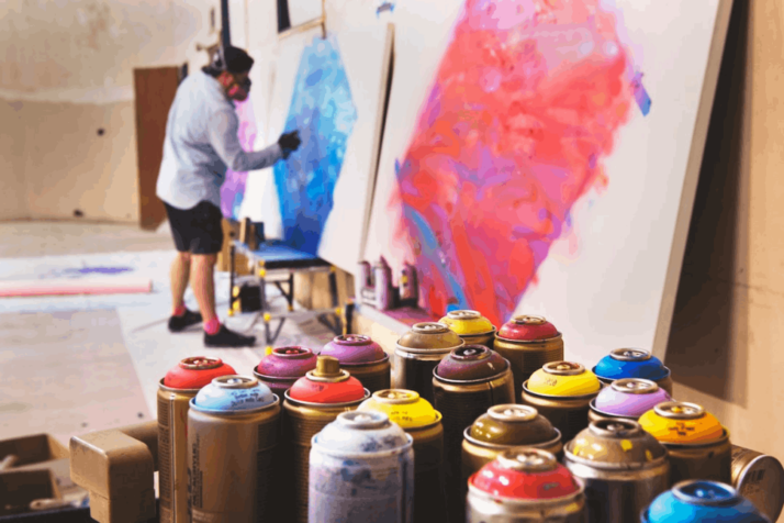 man spraying on white canvas