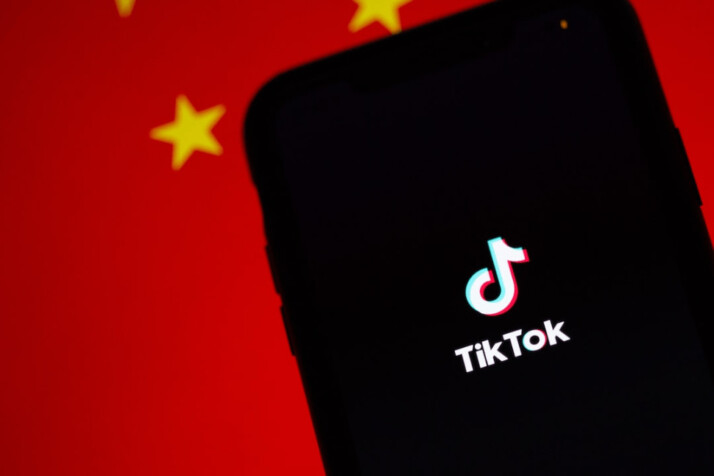 black smartphone showing time displaying TikTok account and icon