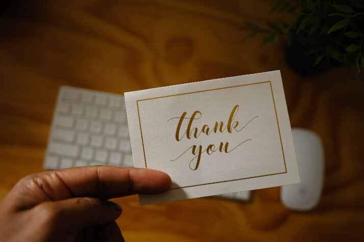 A small note with the words thank you written in cursive.