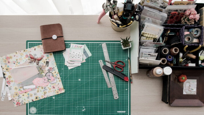 A table filled with all sorts of materials for scrapbooking.