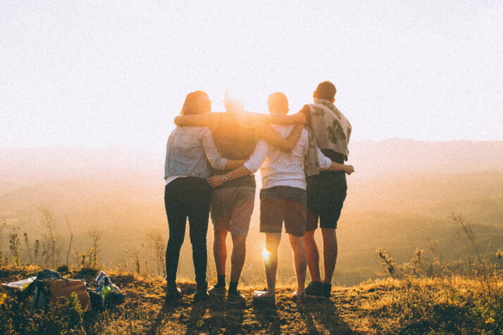 A beautiful photo of friends pictured against the sunset.