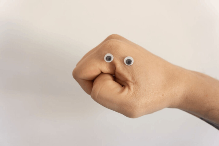 person holding brown heart shaped bread