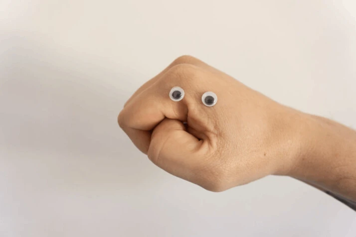 person holding brown heart shaped bread