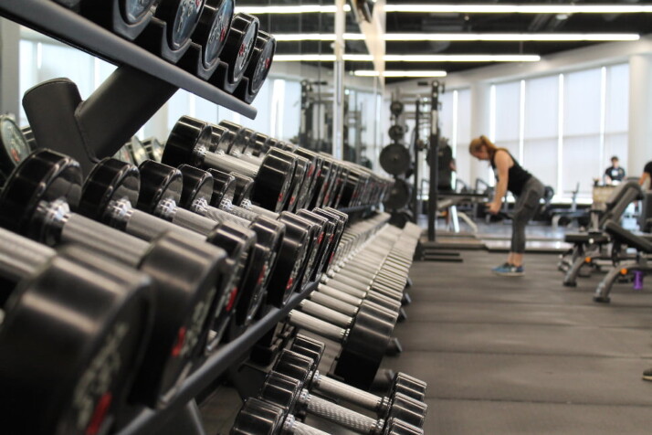 A rack full of heavy weights inside a gym.