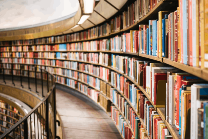 books on the second floor of library on brown wooden shelves