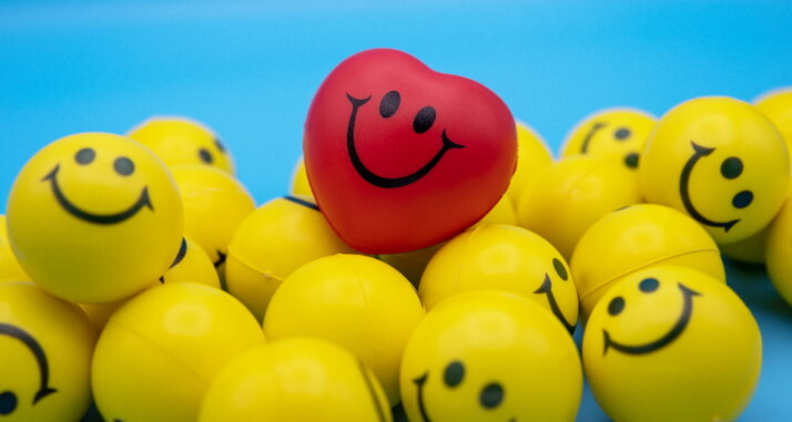 Yellow balls and a red heart with a smile drawn on them.