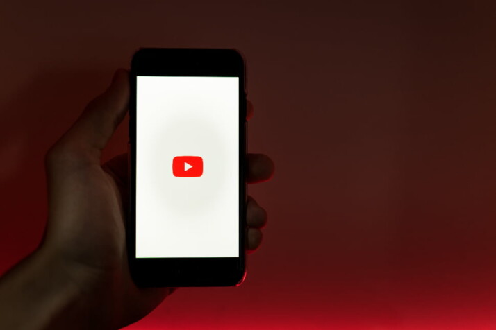 The YouTube official logo displayed on a phone screen,