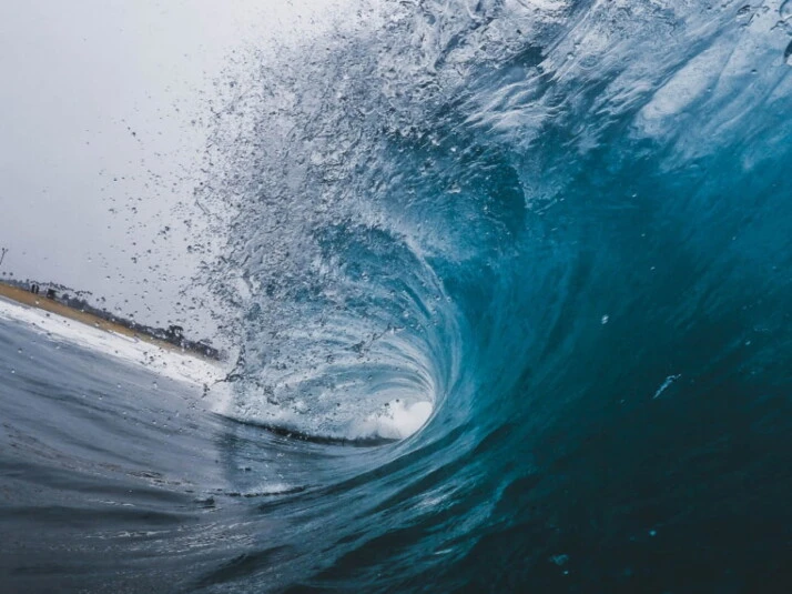 A big blue wave crashing back to the ocean.