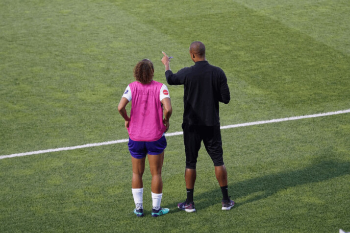 man and woman standing on field