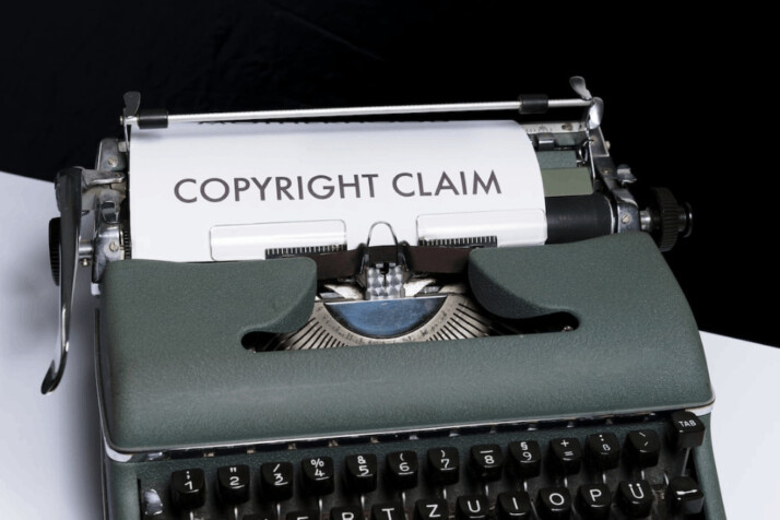 a dark green typewriter that has copyright claim written.