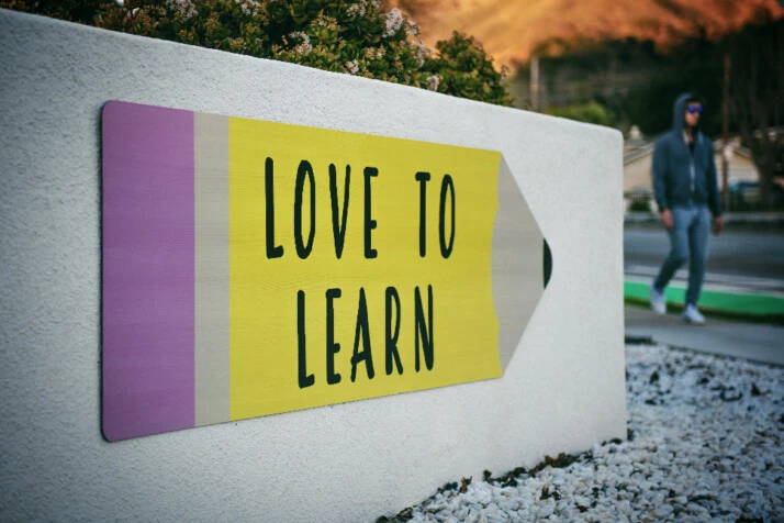 A wall sign in the shape of a pencil that says 