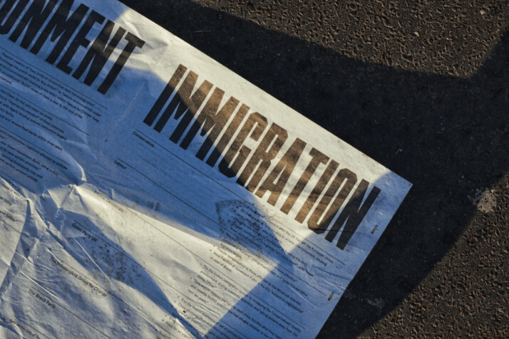 A white printed paper with the word Immigration on it