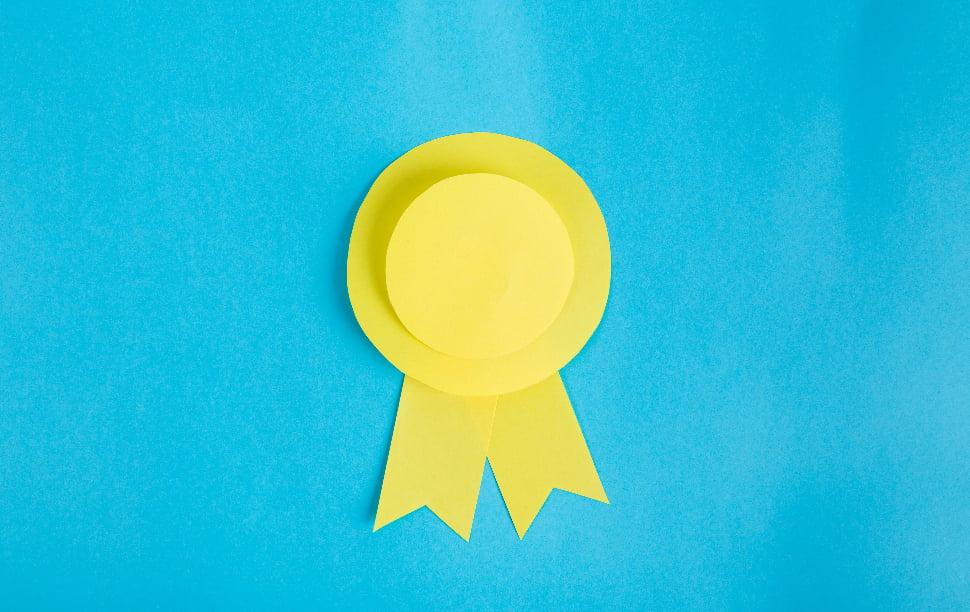 A bright yellow ribbon that has a blue background behind it.