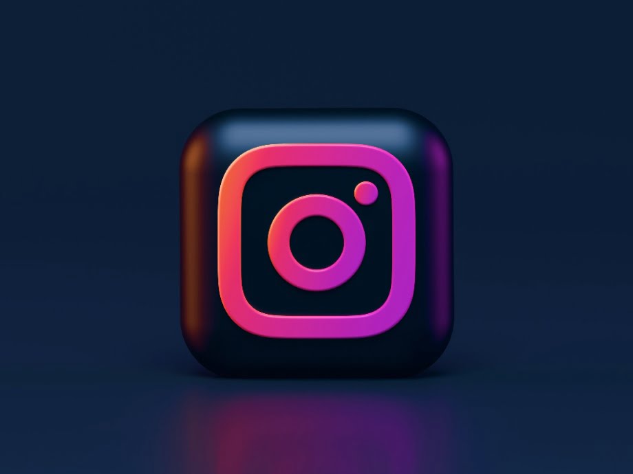 a black and purple 3d Instagram logo in front of black background.