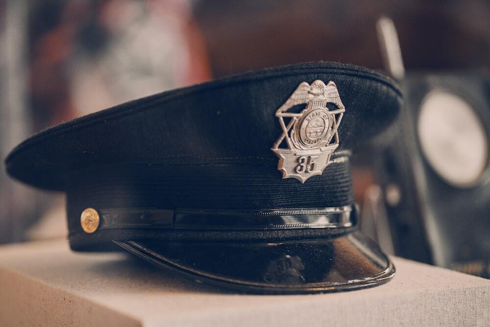 Close-up shot of a police officer's hat on a desk.