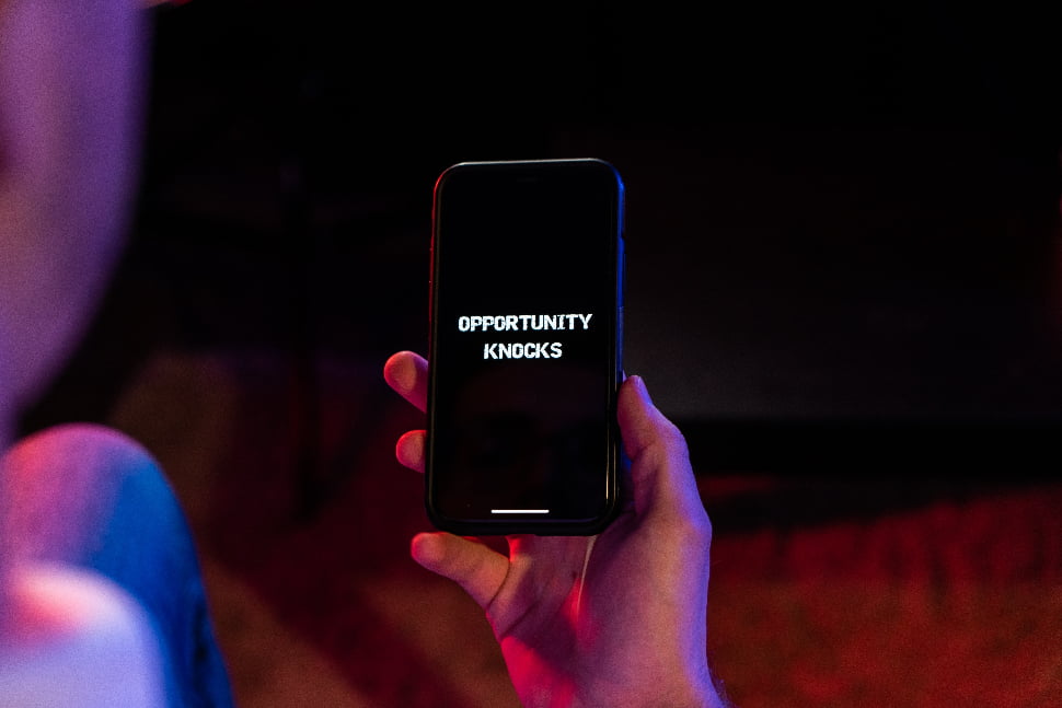 A person holding a phone with the text 