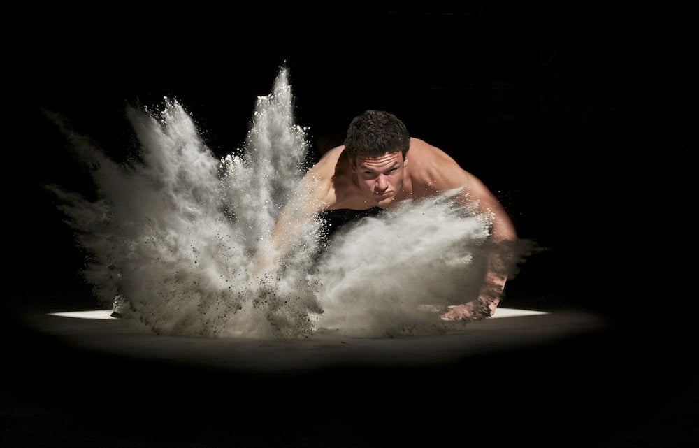 A picture of a muscular man splashing the ground,