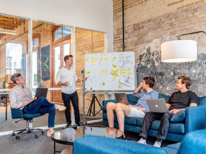 A group of guys having a team meeting in the office.