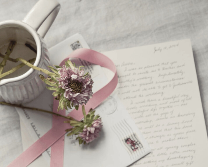 pink and white floral ribbon on white printer paper