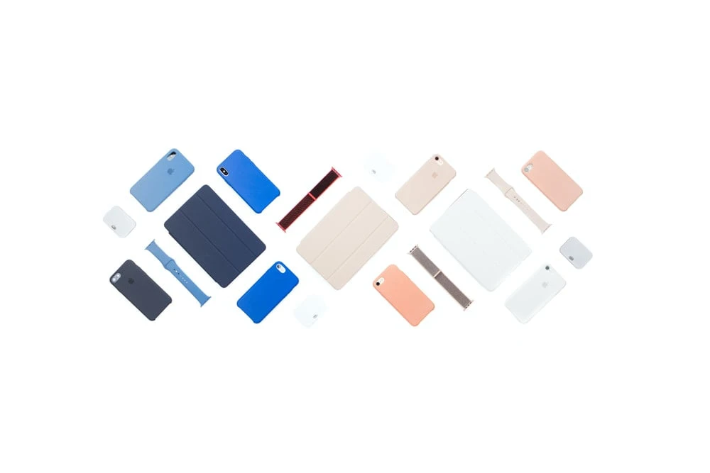 Flat lay of different apple products such as iPhones, iPods, etc.