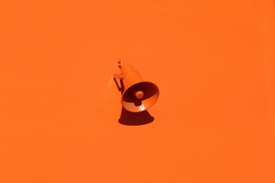 An orange megaphone picture with a similar orange background.